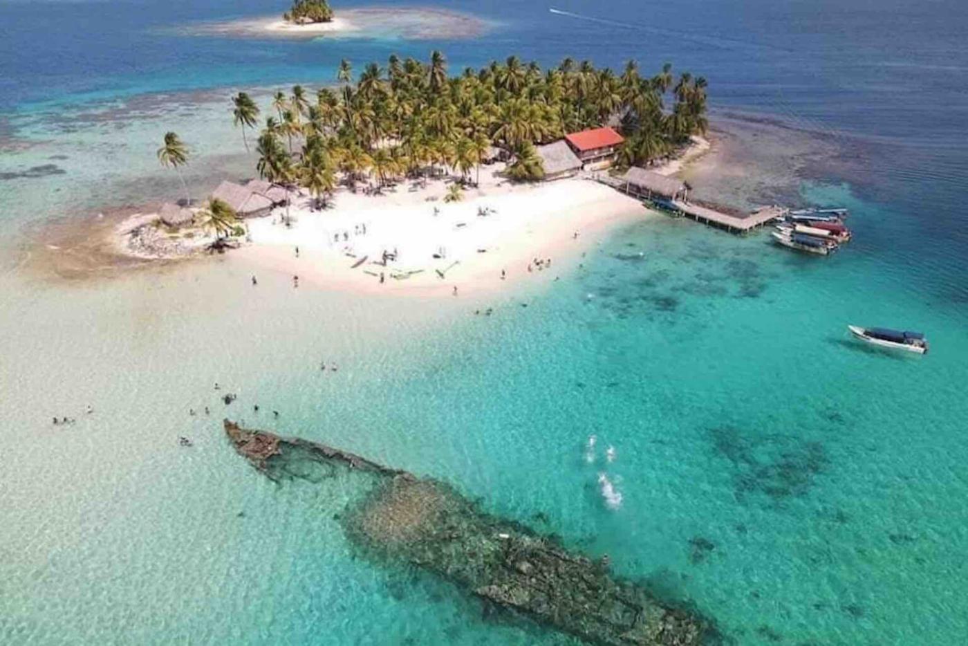 Aerial of a palm island with a submerged shipwreck